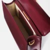 The large Bambino Cross-body metal flap bag